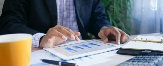 Calculatrice et documents financiers sur un bureau, illustrant l'analyse des coûts cachés d'un recrutement.